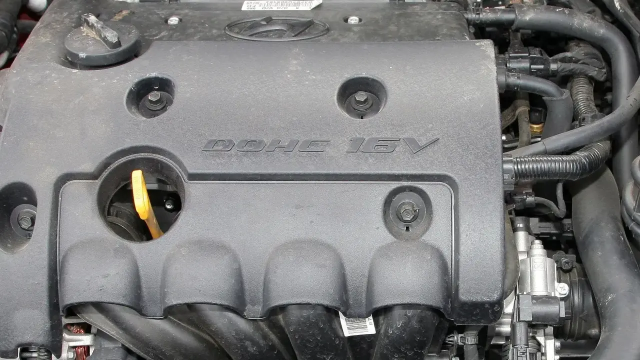 Silnik samochodowy z napisem DOHC 16V. DOHC to skrót od "Double Overhead Camshaft", co oznacza podwójny wałek rozrządu umieszczony nad głowicą.