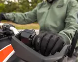 Rękawiczka motocyklisty na kierownicy. Dowiedz się, jak sprawdzić żywotność akumulatora, by zawsze ruszyć w drogę.