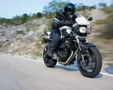 Motocyklista w kasku jedzie na BMW F800R po krętej drodze. Poznaj jego dane techniczne.