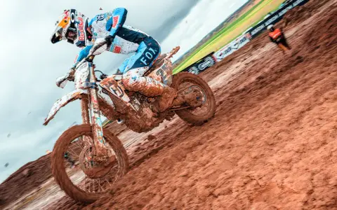 Motocrossowiec w błocie, zastanawia się, co ile filtr powietrza, by utrzymać maszynę w ruchu.