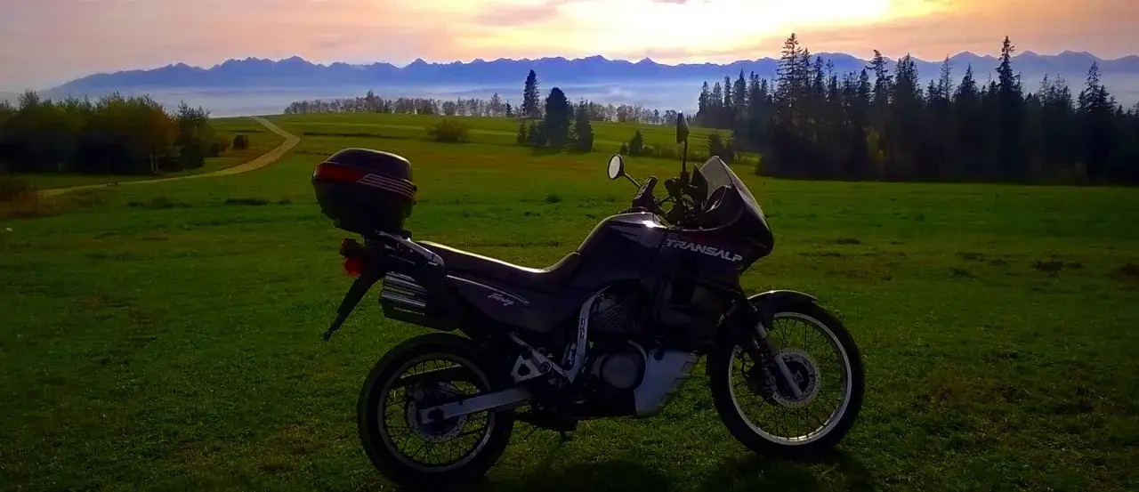 Motocykl Transalp na tle górskiego krajobrazu. Idealny na szlak Orlich Gniazd motocyklem.