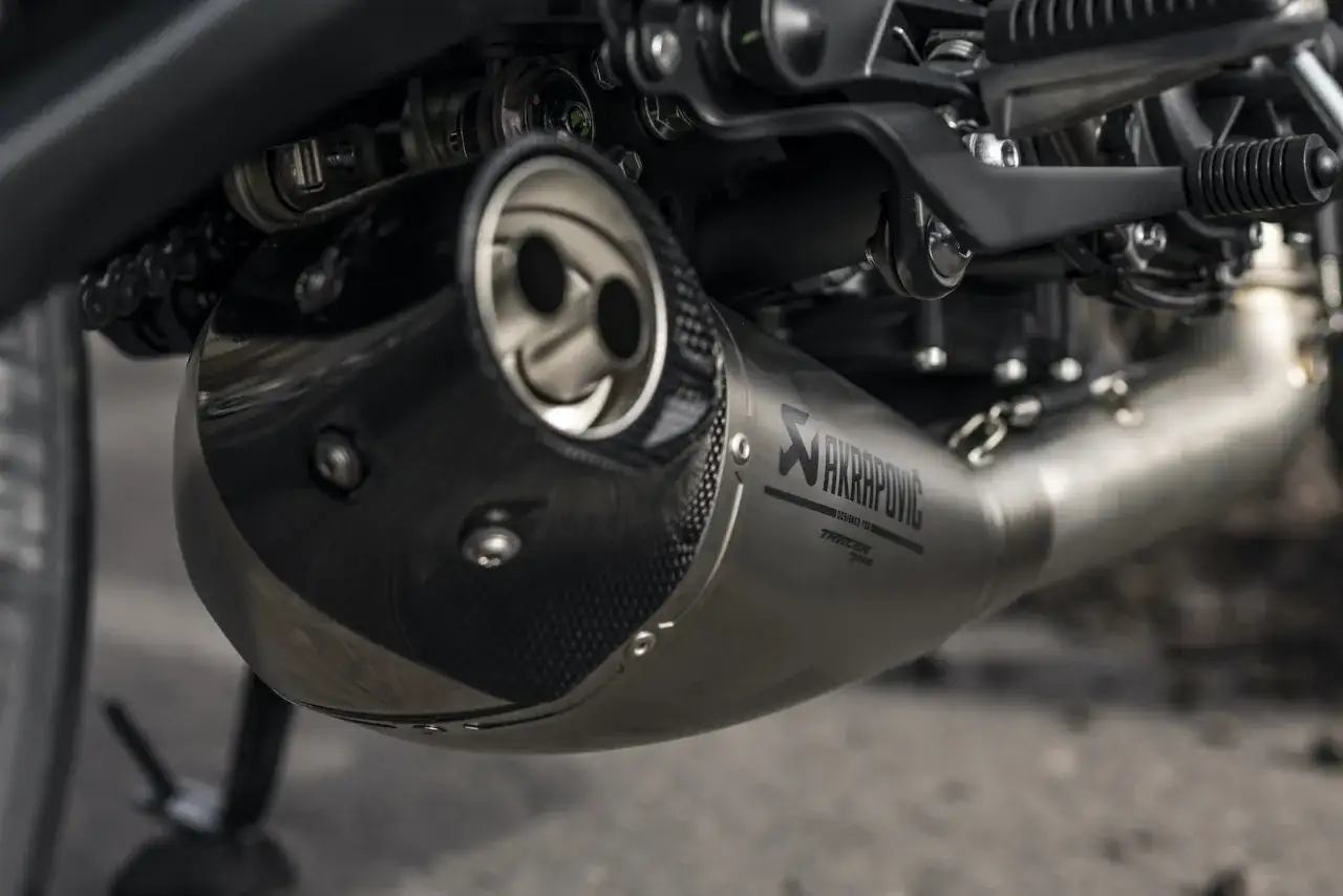 Wydech Akrapovič z włókna węglowego i tytanu, element budowy tłumika motocyklowego.