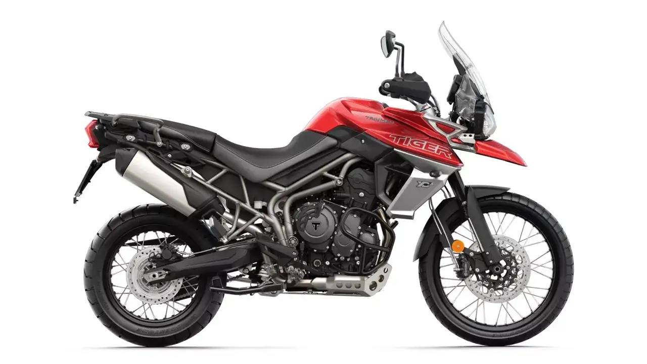 Czerwony motocykl Triumph Tiger 800 XC, gotowy na przygody. Poznaj jego dane techniczne i ruszaj w drogę!