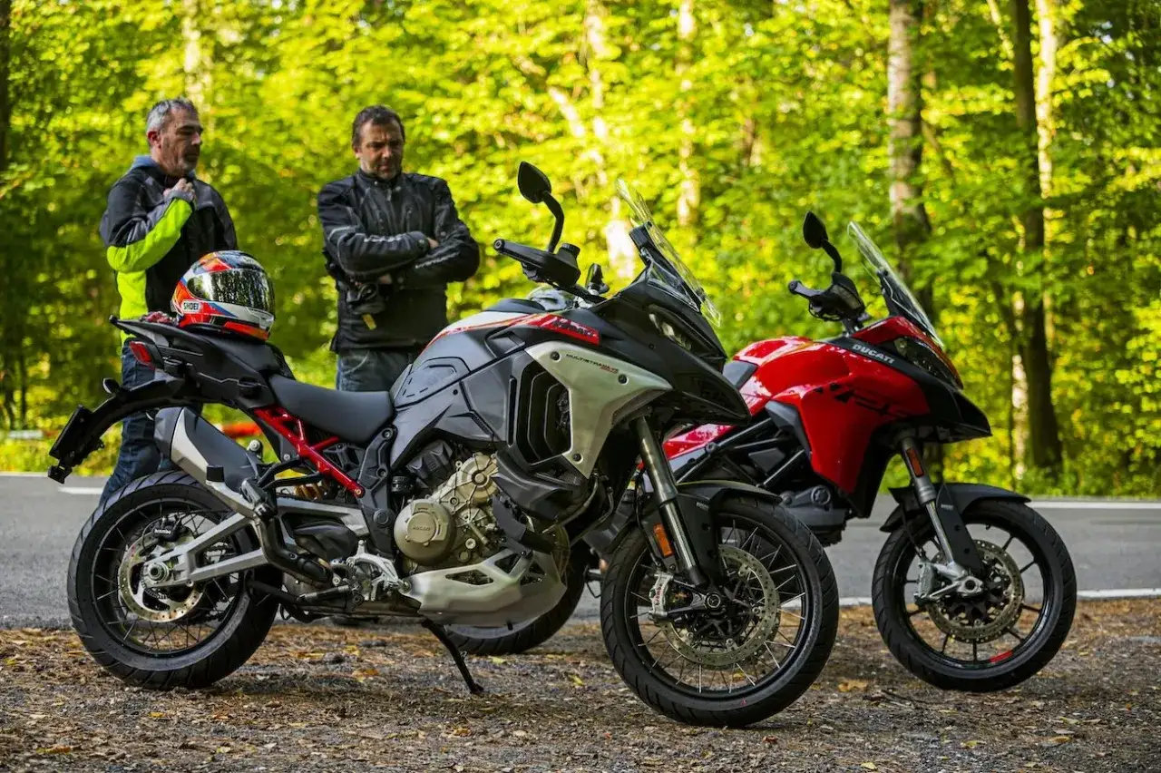 Dwóch motocyklistów obok swoich maszyn: czarnego Ducati Multistrada V2 i czerwonego.