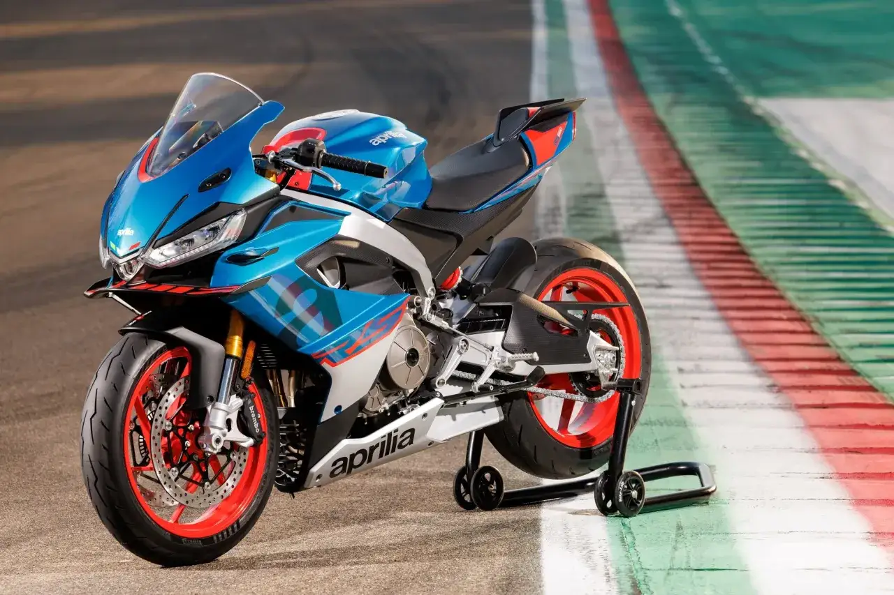 Niebiesko-biały motocykl sportowy Aprilia RS 660 na torze wyścigowym. Sprawdź aprilia rs 660 dane techniczne.