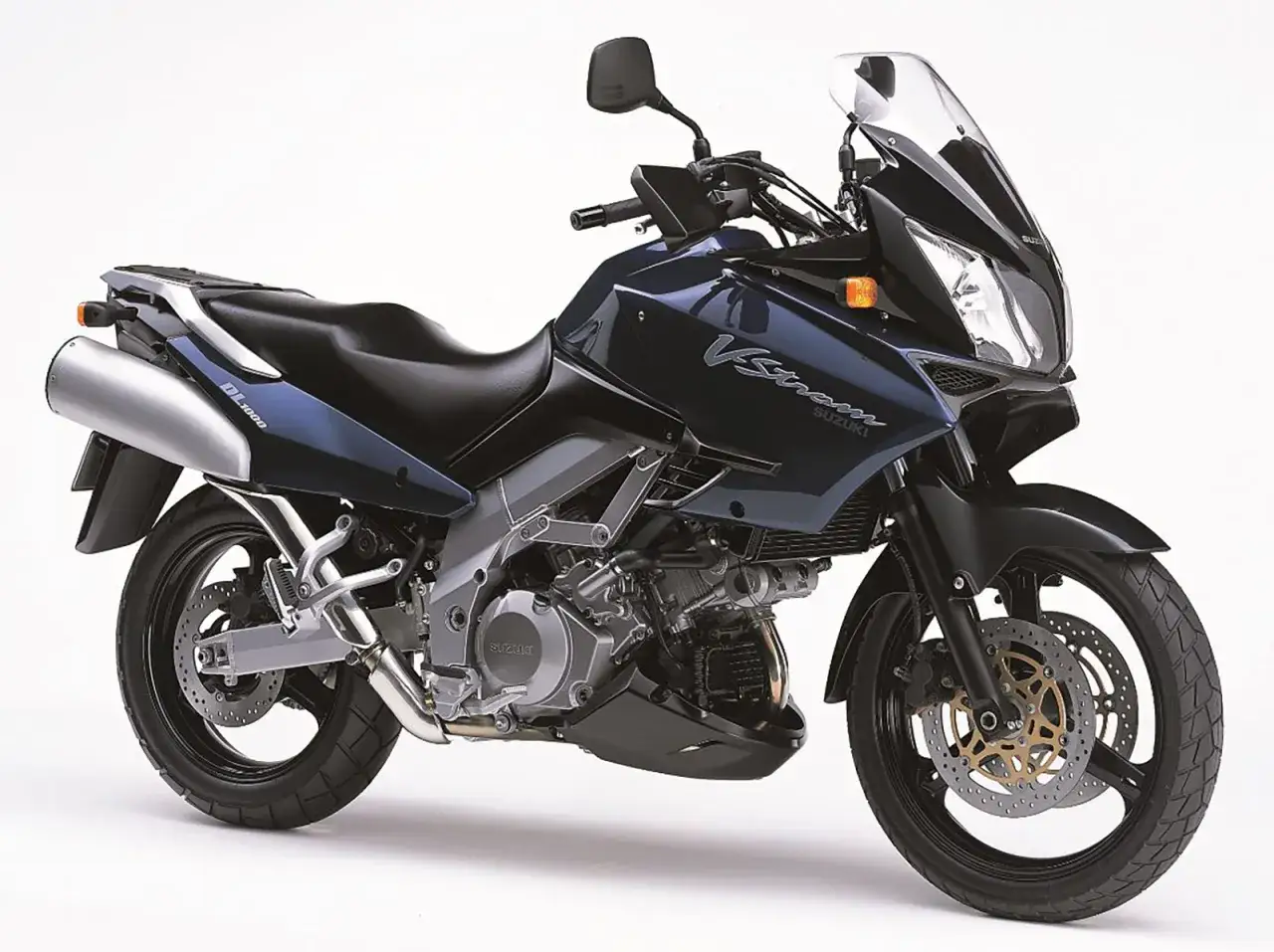 Ciemnoniebieski motocykl Suzuki DL 1000 V-Strom z dużym przednim wiatrochronem i srebrnym wydechem, gotowy na przygodę.